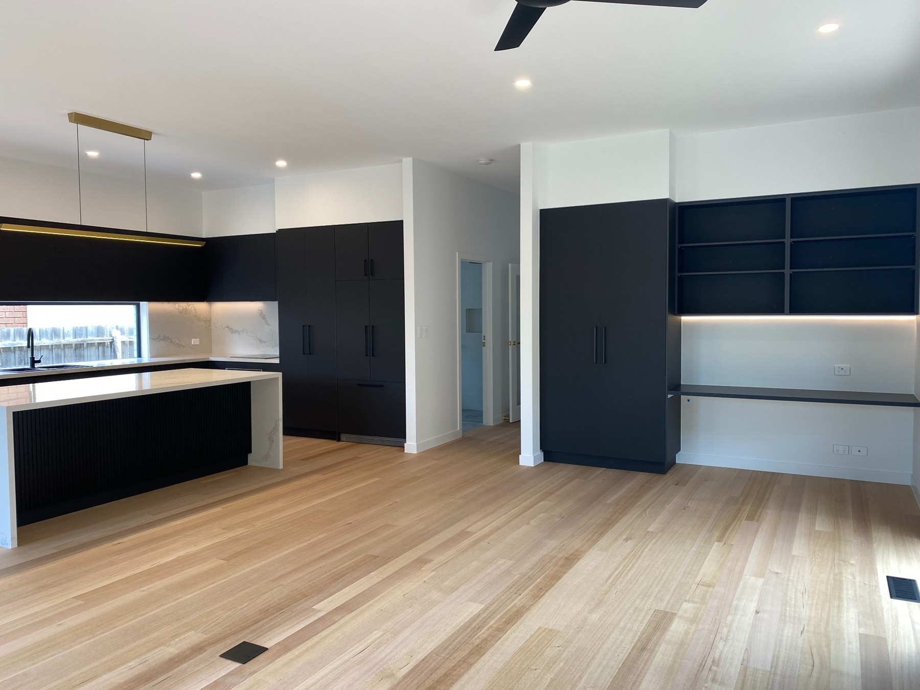 Brunswick renovation with dark cabinetry and timber flooring